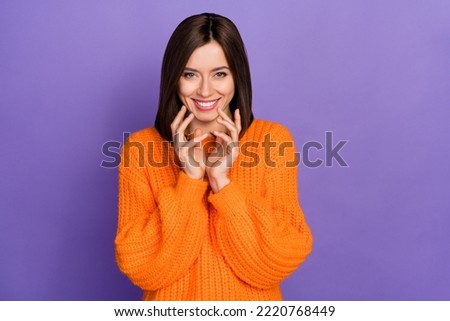 Photo portrait of adorable young girl evil smile planning grimace dressed stylish knitted orange outfit isolated on purple color background