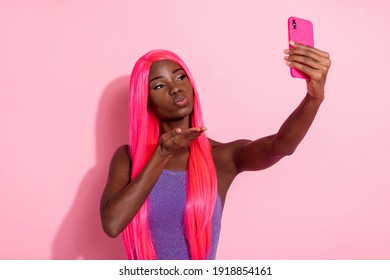 Photo portrait of african american girl taking selfie sending kiss isolated on pastel pink colored background - Powered by Shutterstock