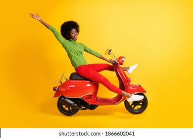 Photo Portrait Of African American Woman Riding Bike Waving Hand With Spread Legs Open Mouth Isolated On Vivid Yellow Colored Background