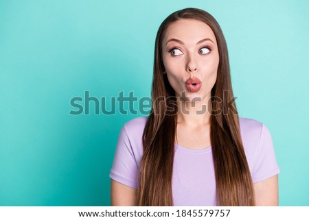Photo portrait of amazed impressed girl starring with opened mouth on empty space isolated on bright teal color background