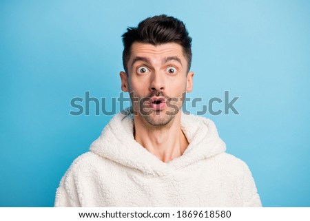 Photo portrait of amazed man with moustache isolated on pastel blue colored background