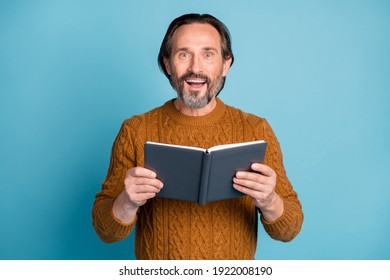 Photo Portrait Of Amazed Smiling Man Keeping Book Reading Novel Literature Isolated On Vivid Blue Color Background