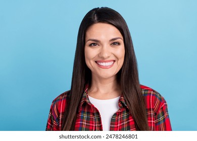 Photo portrait of attractive mature woman friendly smiling looking at you wearing plaid red shirt isolated on blue color background - Powered by Shutterstock