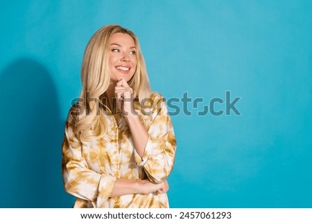 Photo portrait of attractive mature woman minded look empty space dressed stylish formalwear clothes isolated on cyan color background