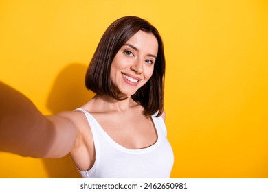 Photo portrait of attractive young girl take selfie wear trendy white outfit isolated on yellow color background - Powered by Shutterstock