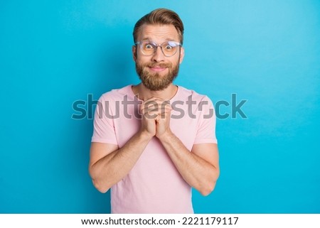 Photo portrait of attractive young guy eyeglasses adorable hands together dressed stylish pink look isolated on aquamarine color background