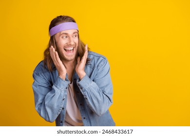 Photo portrait of attractive young hippie man raise hands look empty space wear trendy denim outfit isolated on yellow color background - Powered by Shutterstock