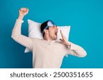 Photo portrait of attractive young man lying pillow yawning dressed pajama sleepover good night isolated on blue color background