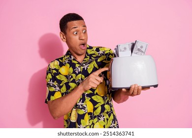 Photo portrait of attractive young man amazed hold toaster money dressed stylish tropical print clothes isolated on pink color background - Powered by Shutterstock