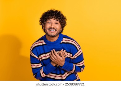 Photo portrait of attractive young man touch chest laugh thankful dressed stylish blue striped clothes isolated on yellow color background - Powered by Shutterstock