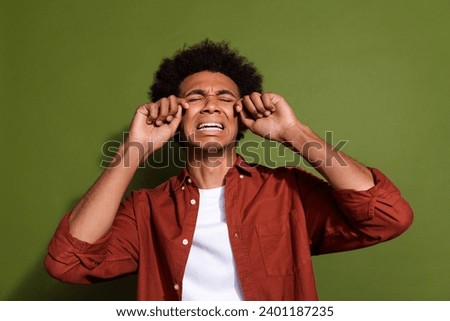 Photo portrait of attractive young man crying tears weep dressed stylish brown clothes isolated on khaki color background