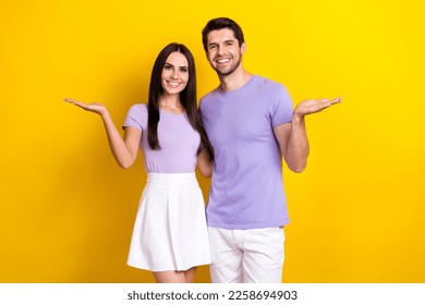 Photo portrait of attractive young woman man palms hold empty space product dressed stylish violet look isolated on yellow color background - Shutterstock ID 2258694903