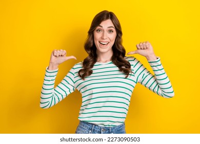 Photo portrait of attractive young woman pointing self excited winner lottery wear trendy striped look isolated on yellow color background