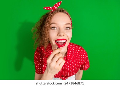 Photo portrait of attractive young woman apply lipstick dressed stylish red retro clothes isolated on green color background - Powered by Shutterstock