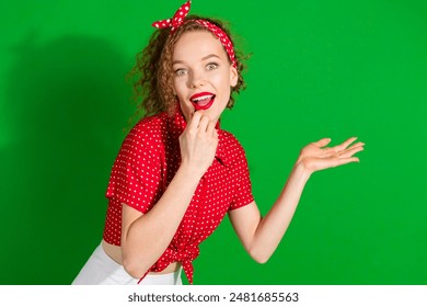 Photo portrait of attractive young woman apply pomade lips dressed stylish red retro clothes isolated on green color background - Powered by Shutterstock