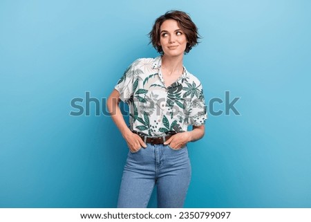 Photo portrait of attractive young woman pockets look empty space dressed stylish print leaves clothes isolated on blue color background