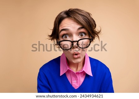 Photo portrait of attractive young woman plump lips excited dressed stylish blue clothes isolated on beige color background