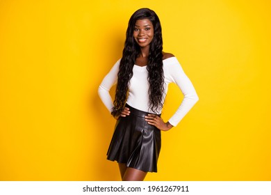 Photo portrait of black skinned woman smiling in stylish clothes isolated vivid yellow color background