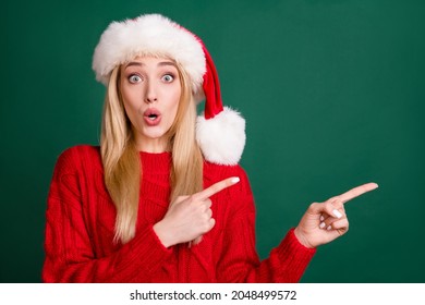 Photo portrait blonde woman in santa hat showing fingers blank space amazed isolated green color background - Powered by Shutterstock