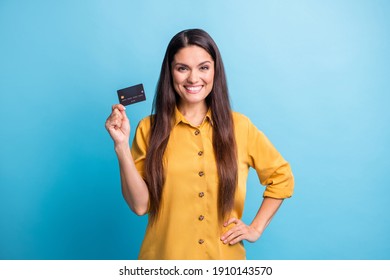 Photo portrait of business woman smiling keeping bank card with salary savings isolated on bright blue color background