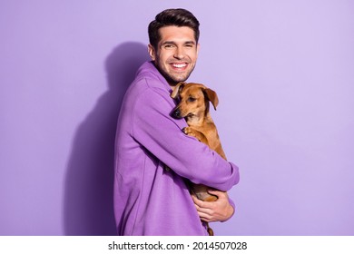 Photo Portrait Cheerful Man In Hoody Smiling Keeping Little Dog Isolated Pastel Purple Color Background