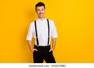 Photo portrait of cheerful positive smiling gentleman wearing shirt suspenders isolated on vibrant yellow color background