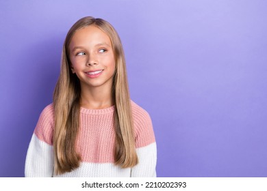 Photo Portrait Of Cheerful Satisfied Girl Interested Look Empty Space Dressed Trendy Pullover Isolated On Purple Color Background