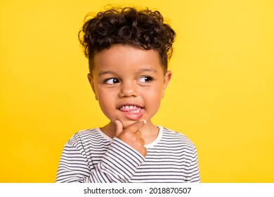 Photo portrait cheerful small boy looking copyspace in striped shirt isolated bright yellow color background - Powered by Shutterstock