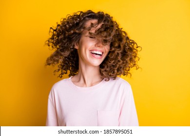 Photo Portrait Of Cool Girl With Wavy Flying Hair Isolated On Vivid Yellow Colored Background