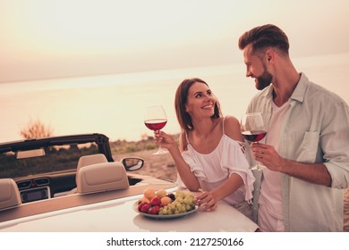 Photo portrait couple have romantic dinner drinking wine eating fruit on car on beach in summer - Powered by Shutterstock