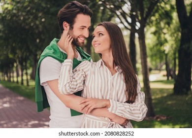 Photo portrait couple spending time in park happy holding hands smiling looking at each other girl touching man face