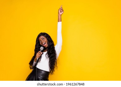 Photo Portrait Of Curious Black Skinned Woman Singing Song Keeping Microphone Dancing Isolated Bright Yellow Color Background Blank Space