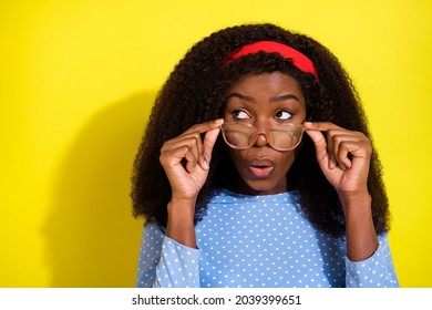 Photo portrait of curly girl wearing headband glasses looking empty space amazed isolated bright yellow color background - Powered by Shutterstock