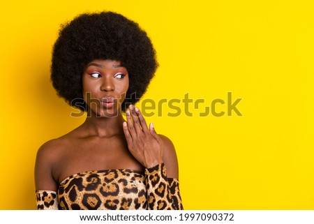 Photo portrait curly woman wearing printed leopard top looking copyspace amazed isolated bright yellow color background