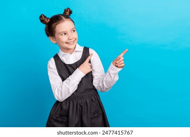 Photo portrait of cute little girl point look empty space dressed stylish school uniform isolated on blue color background - Powered by Shutterstock