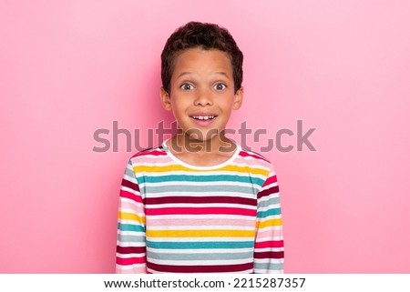 Photo portrait of cute little hispanic boy impressed good news excited sales wear stylish striped outfit isolated on pink color background
