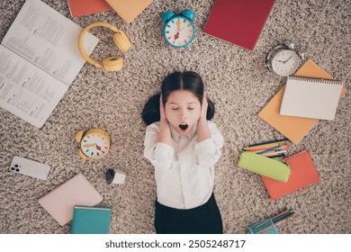 Photo portrait of cute small schoolgirl lying floor cover ears ignore clock time ring stressed home education concept school interior - Powered by Shutterstock