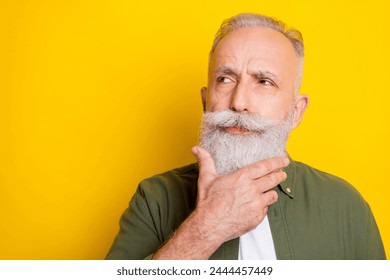 Photo portrait of elder man looking empty space thoughtful isolated vivid yellow color background - Powered by Shutterstock