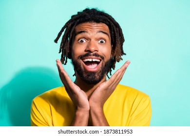Photo portrait of excited black skin man with open mouth raised arms isolated on vivid teal colored background