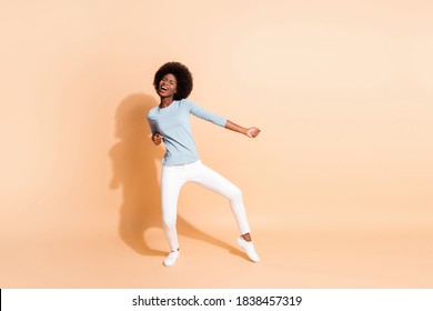 Photo Portrait Full Body View Of African American Woman Dancing Enjoying Party Isolated On Pastel Beige Colored Background