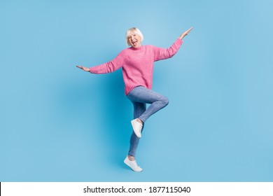 Photo Portrait Full Body View Of Happy Old Lady Dancing Standing On One Leg Isolated On Pastel Blue Colored Background