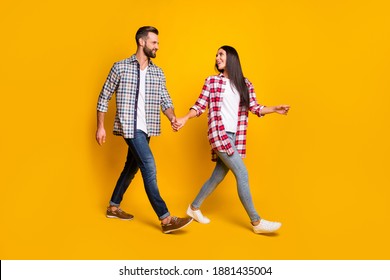 Photo Portrait Full Body View Of Man And Woman Holding Hands Walking Isolated On Vivid Yellow Colored Background