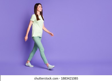 Photo portrait full body view of girl walking forward to blank space isolated on vivid violet colored background