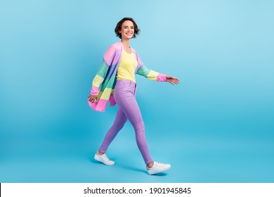 Photo portrait full body view of smiling girl walking isolated on pastel blue colored background - Shutterstock ID 1901945845