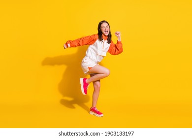 Photo portrait full body view of crazy dancing woman screaming isolated on vivid yellow colored background - Shutterstock ID 1903133197