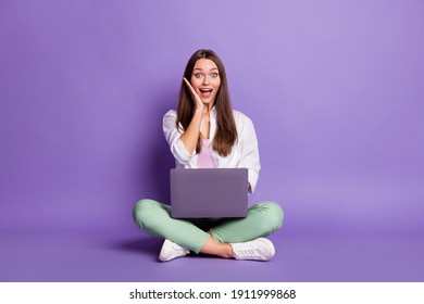 Photo Portrait Full Body View Of Woman With Laptop Sitting In Lotus Pose Isolated On Vivid Purple Colored Background