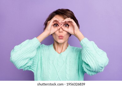 Photo Portrait Funny Girl Keeping Hands Like Binocular Staring In Knitted Sweater Isolated On Pastel Violet Color Background