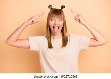 Photo Portrait Of Funny Model Showing Tongue Grimacing Pointing Hairdo Staring Silly Isolated On Pastel Beige Color Background