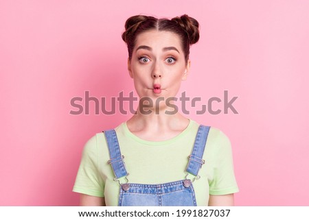 Photo portrait girl with bun fooling grimacing funny face isolated pastel pink color background