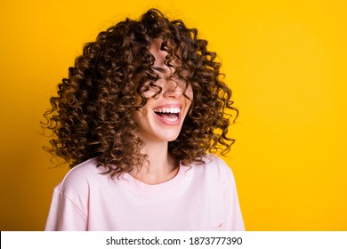 Photo portrait of girl with curly hairstyle wearing t-shirt laughing with closed eyes isolated on bright yellow color background - Shutterstock ID 1873777390